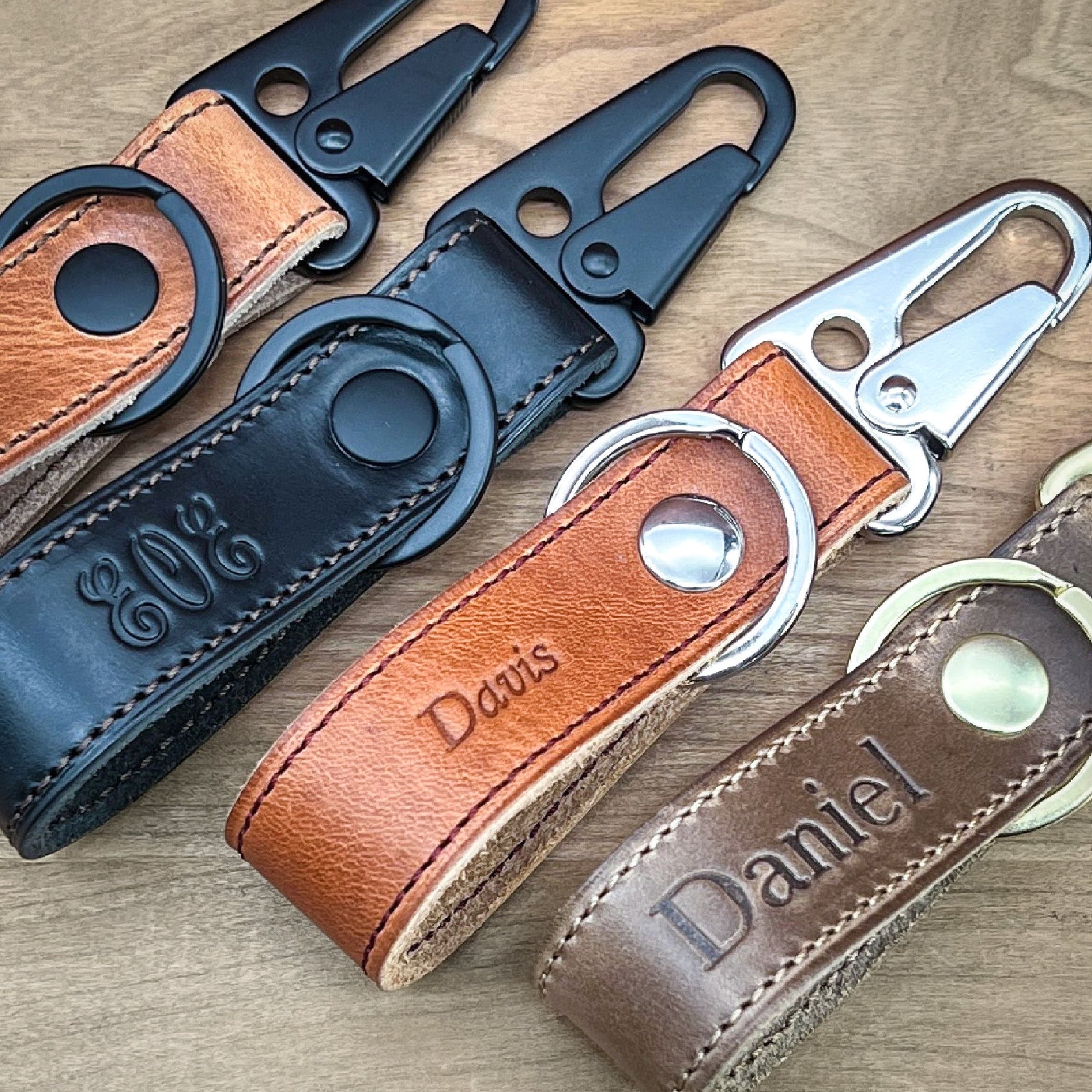 Handmade Clip Keychains in 4 different Horween leathers highlighting the black, nickel and brass finished hardware.