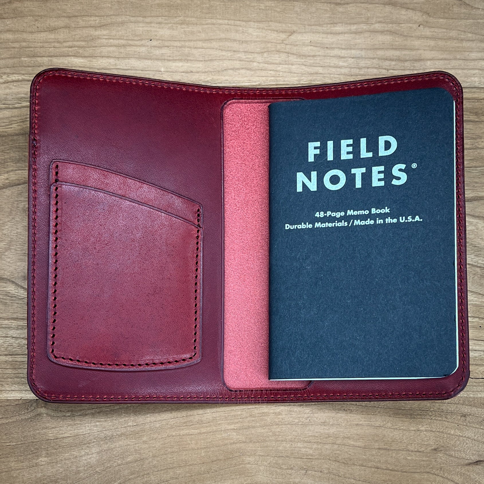 Interior of custom notebook cover in red Horween leather.