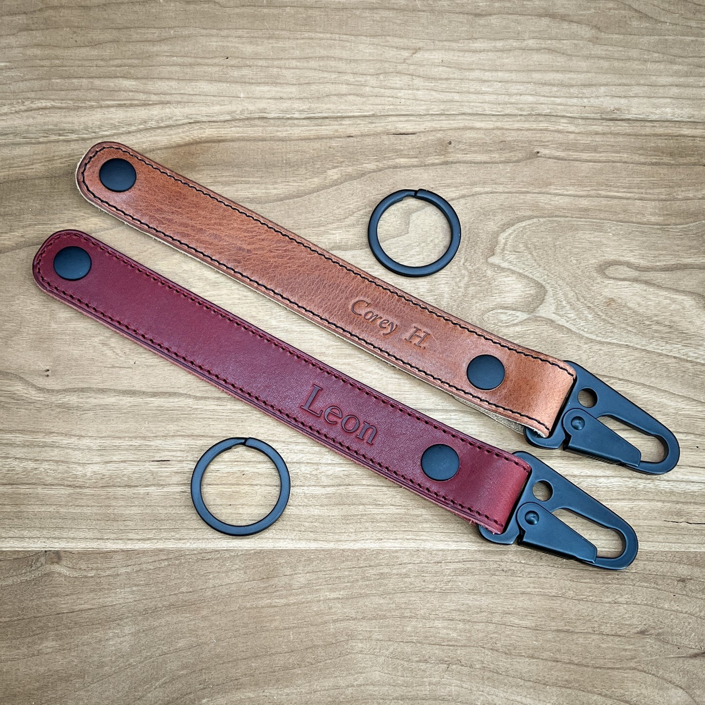 Two belt look clip keychains in Horween leather. Unsnapped to show the length and removable keyring.