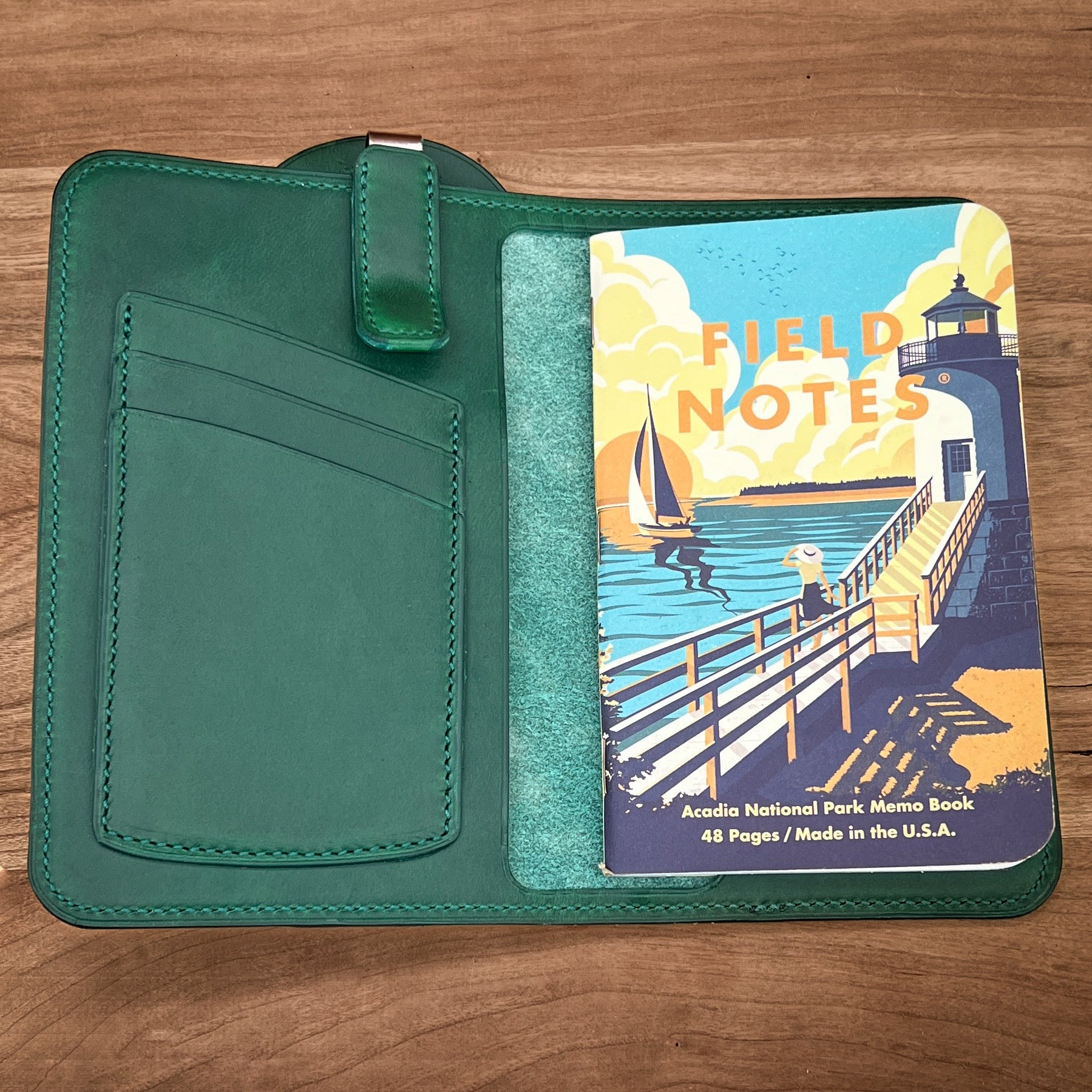 Green Horween Leather Notebook Cover with attached pen holder showing the interior with the matching leather wrapped clip and Field Notes notebook