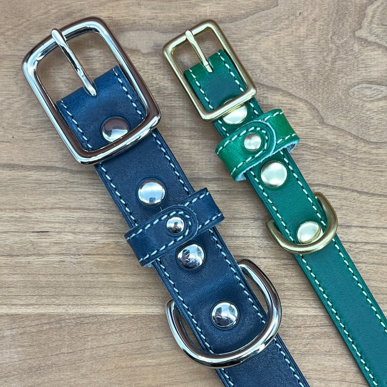Two Custom Leather Dog Collars in Blue and Green with brass and nickel hardware.