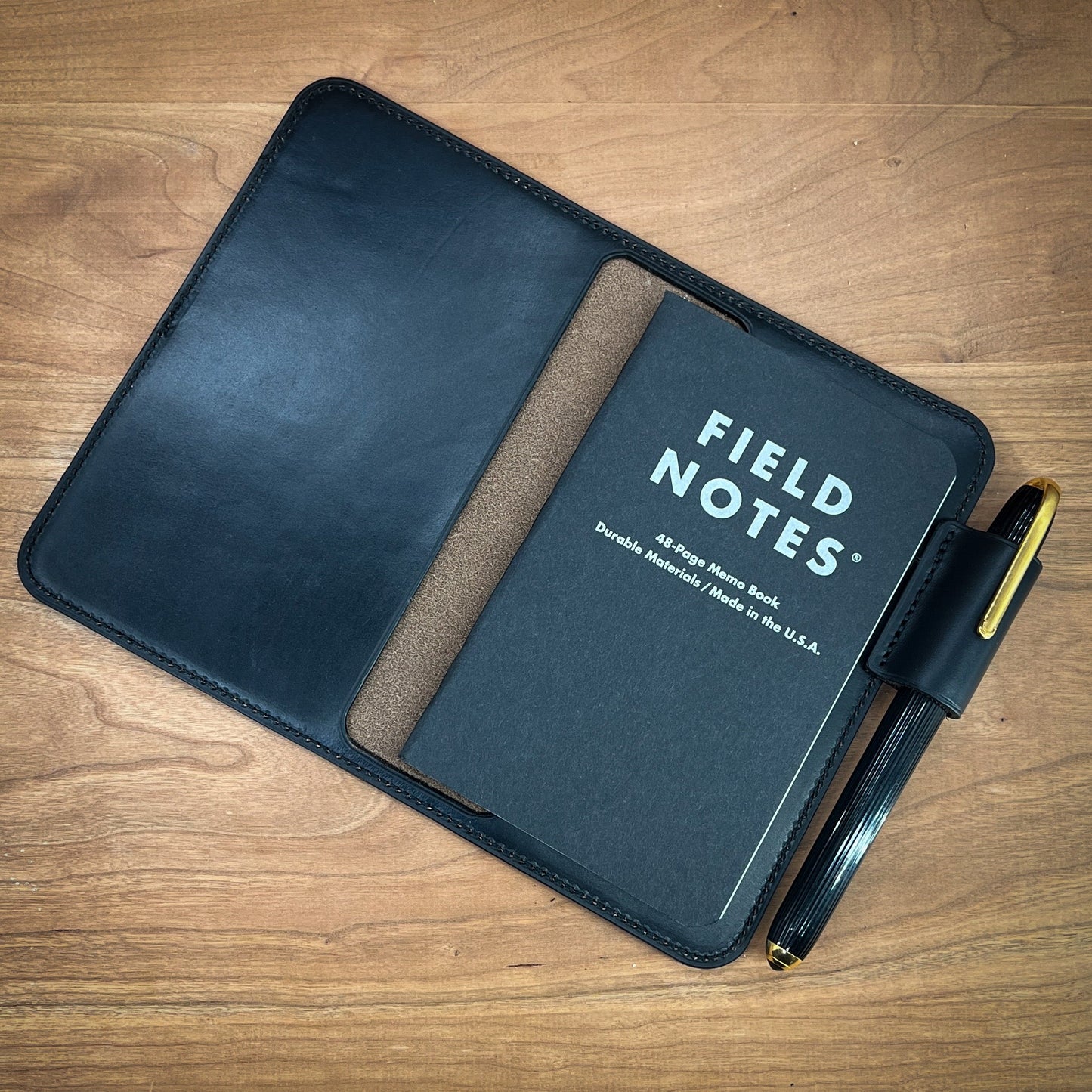 Handmade Black CXL Horween notebook cover. Basic style with external pen holder and matching stitching. Handmade by Custom Leather and Pen in Houston, TX