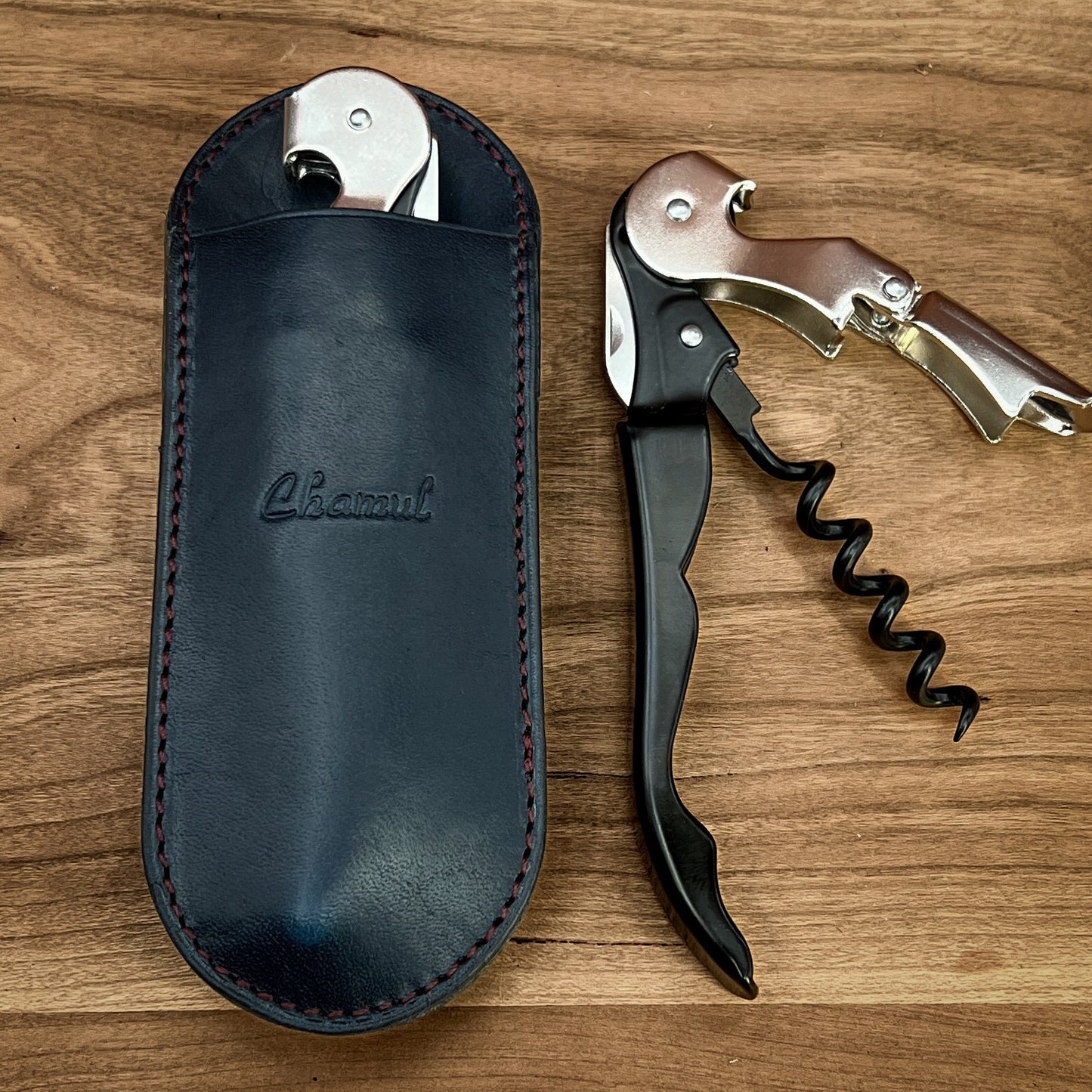 Handmade Leather Corkscrew Case and Pulltap Corkscrew. The handmade corkscrew case is shown in cobalt blue horween leather with burgundy stitching. it is handmade by Custom Leather and Pen in Houston, Texas