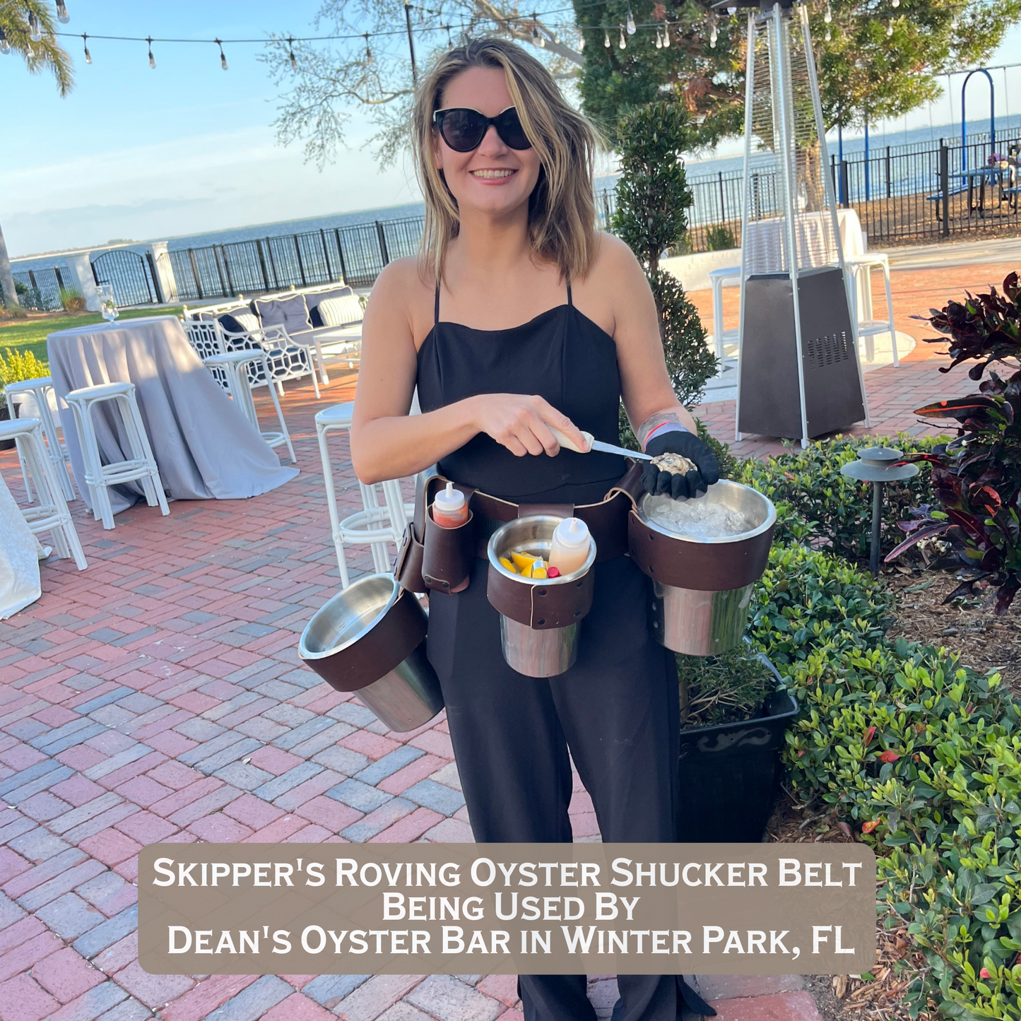 Skipper’s Oyster Shuckers Belt being used at a Catering Event with Fresh Oysters by an attractive lady shucking oysters.