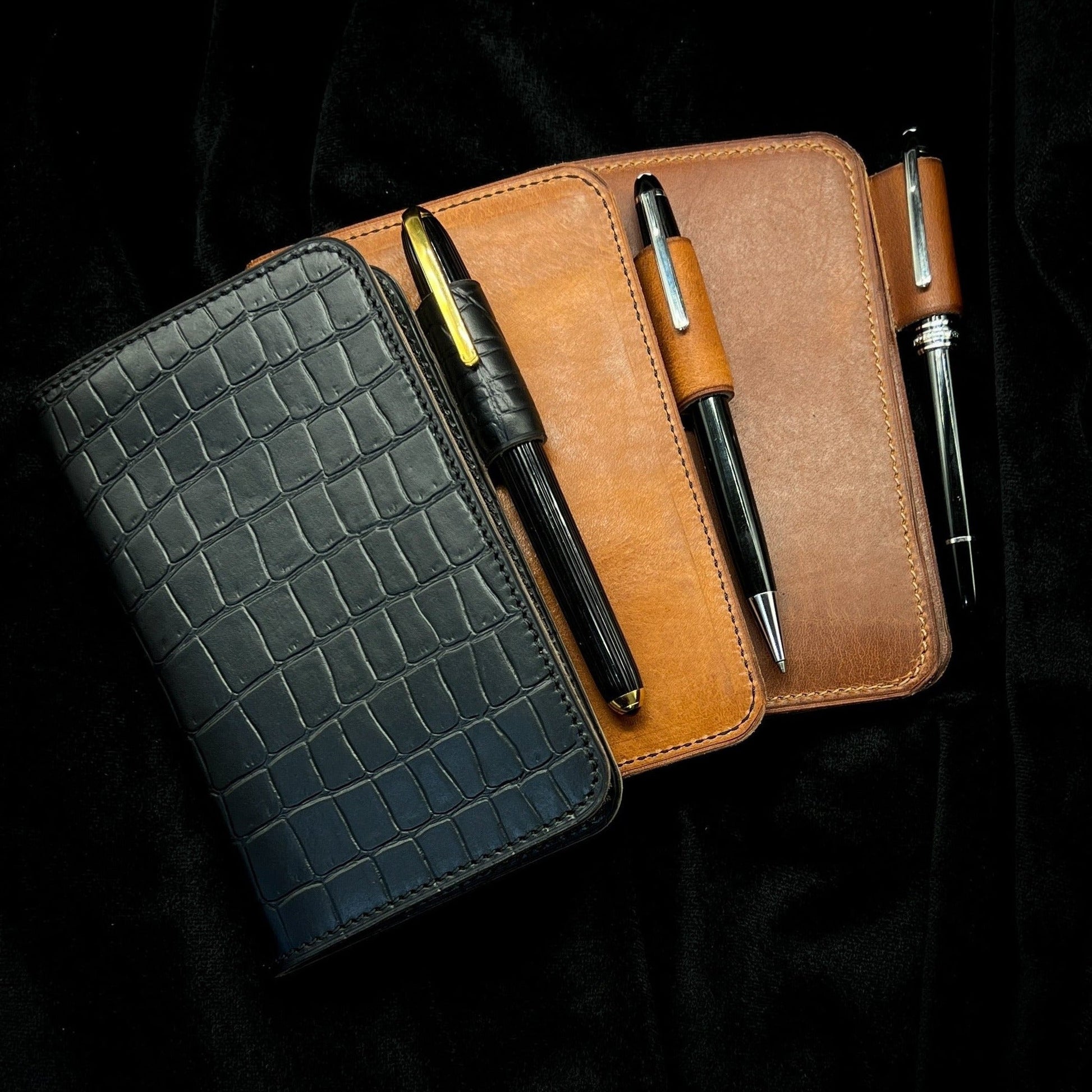 Collection of Handmade Notebook Covers in Horween Leather by Custom Leather and Pen in Houston, TX featuring Cartier and Monteblanc Pens