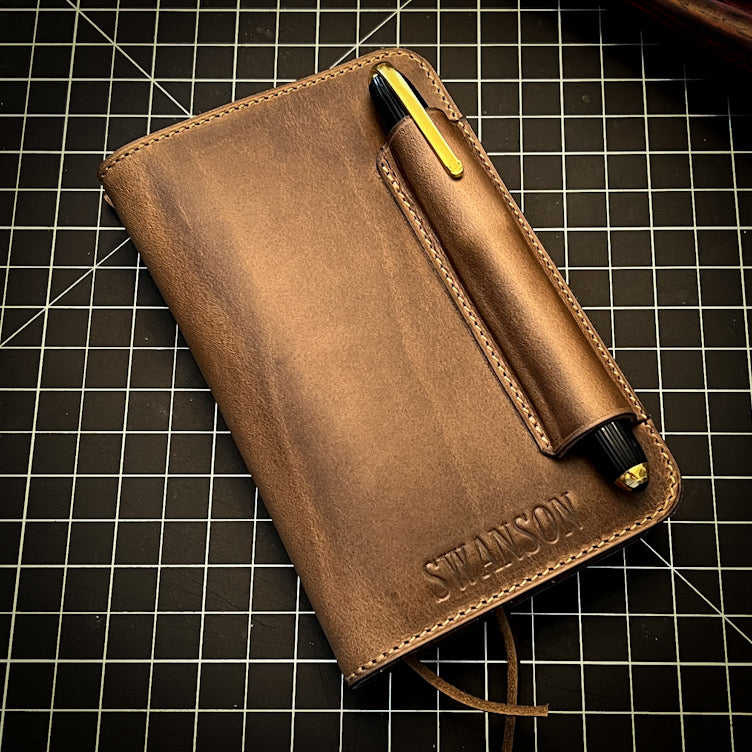 Handmade Notebook Cover with Pen Holder on Top holding a Cartier Pen.  Custom Made to Order by Custom Leather and Pen in Houston, TX