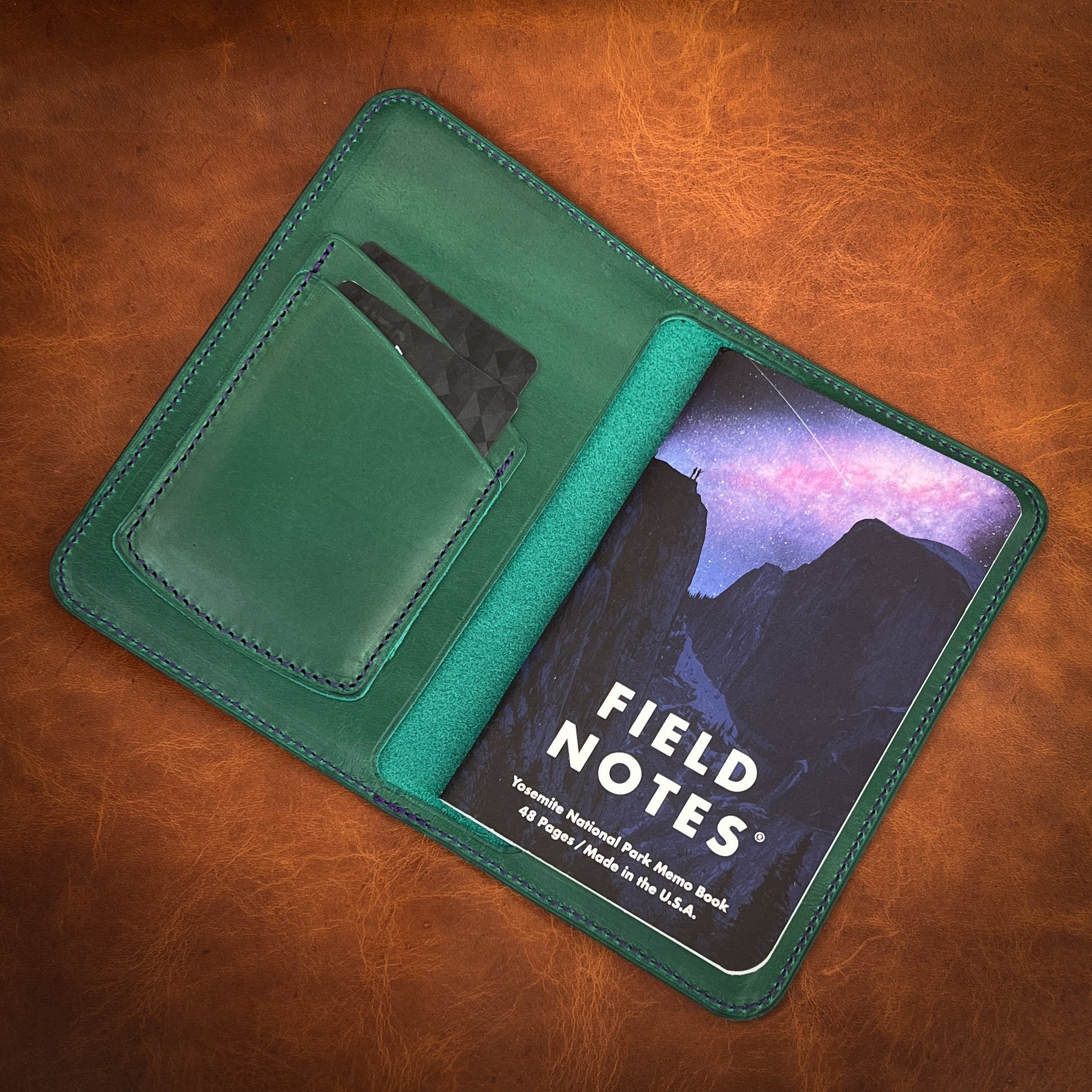 Beautiful Golf Green Horween Leather notebook cover with two credit card pockets and a night sky field notes refill.  Handmade by Custom Leather and Pen in Houston, TX.