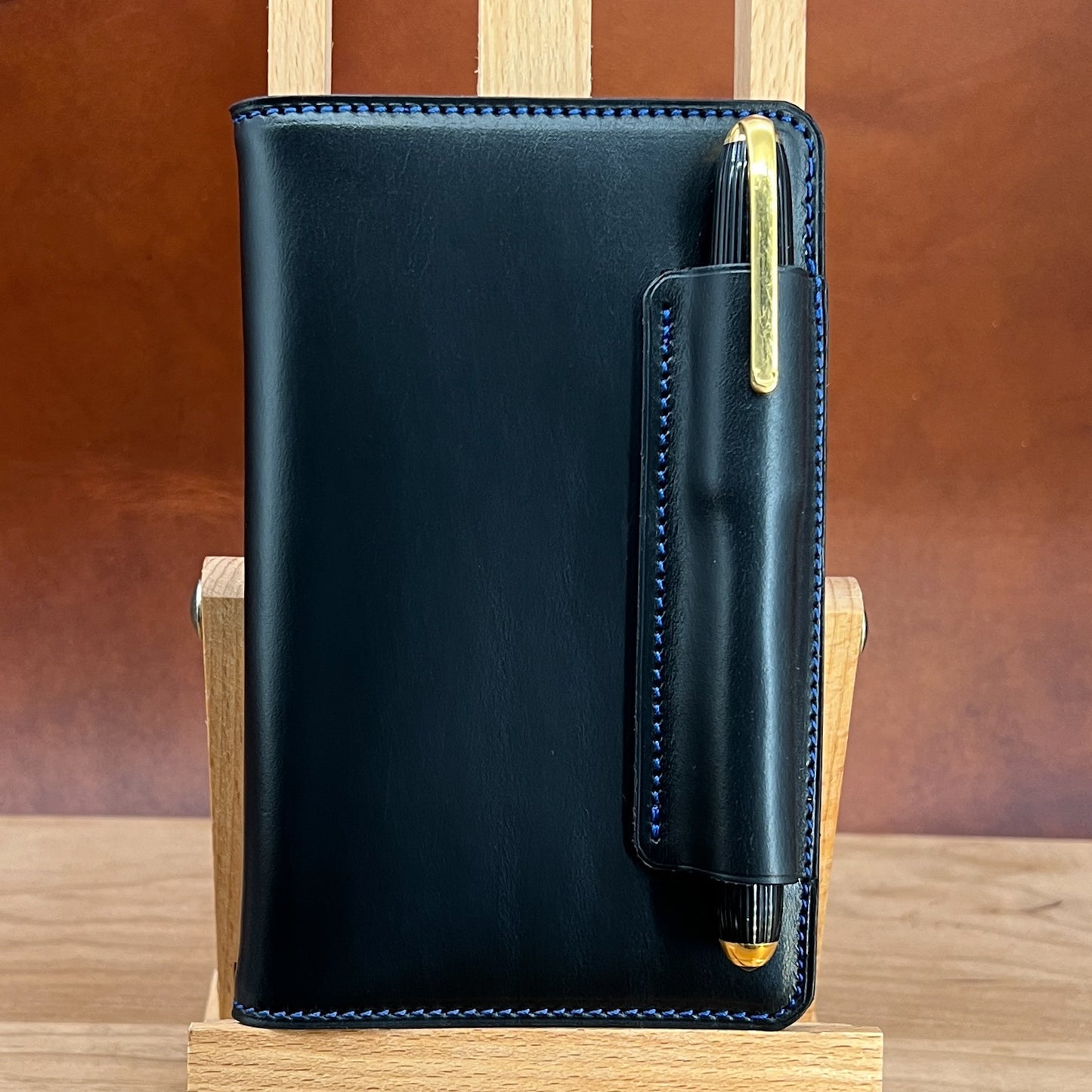 Handmade Leather Notebook cover in Black Horween leather with custom sized Fountain Pen holder.  Handmade by Custom Leather and Pen in Houston Texas.