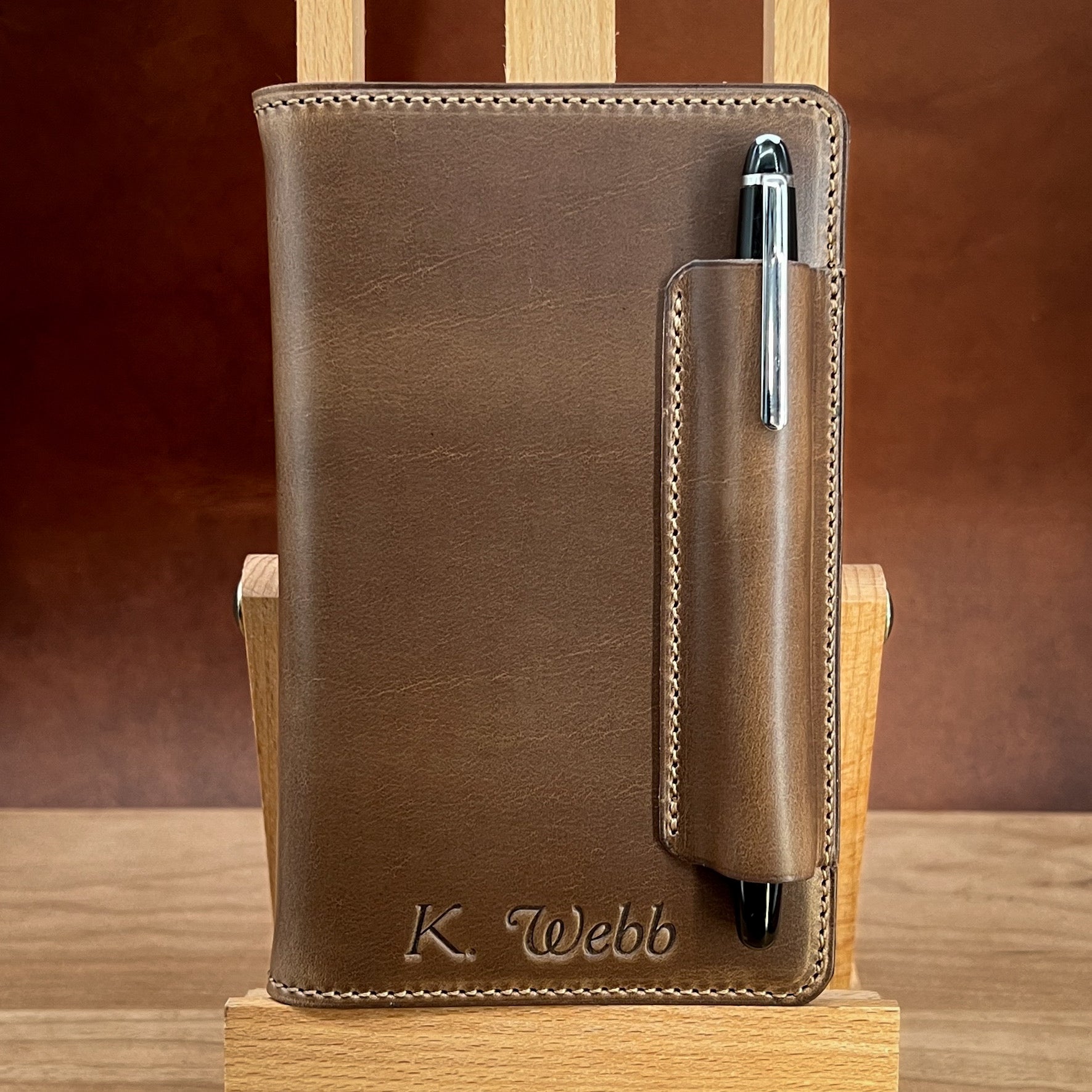 Horween Leather Notebook Cover with Pen Holder for Pocket Sized Notebooks including Field Notes.  Made with Natural CXL Horween leather and personalized with a heat stamped name. Handmade by Custom Leather and Pen