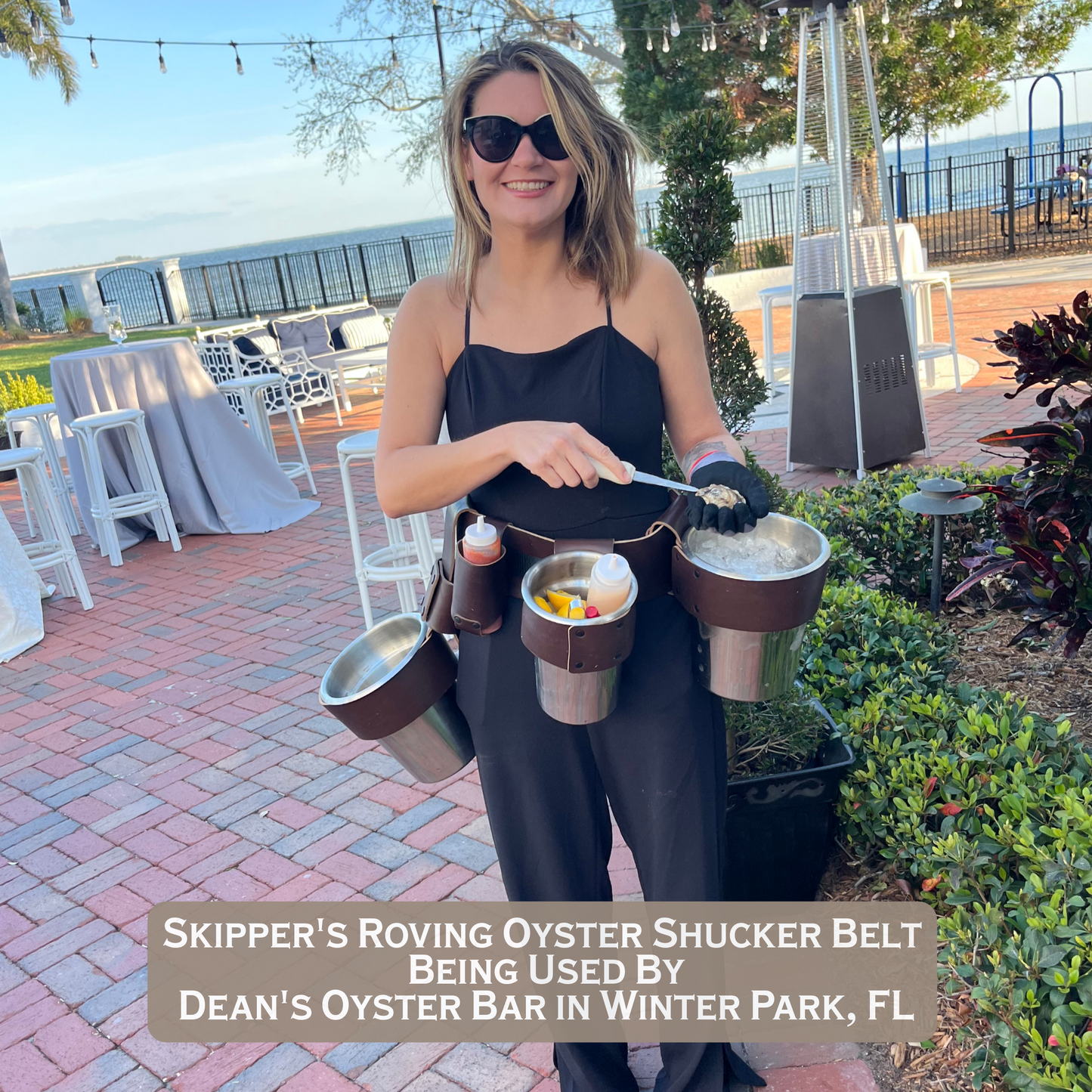 Skipper’s Oyster Shuckers Belt being used at a Catering Event with Fresh Oysters by an attractive lady shucking oysters.  